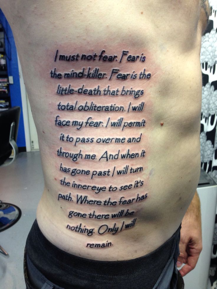 the back of a man's stomach with words written on it