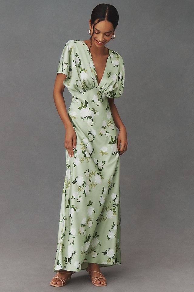 a woman in a green floral print dress