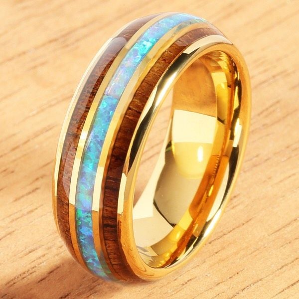 a gold ring with blue and yellow opal inlays on the inside of it