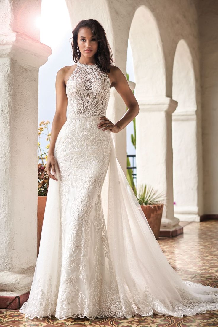 a woman in a wedding dress posing for the camera