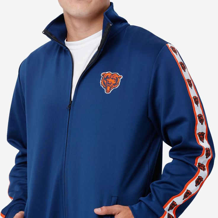 A jacket that you'll be jacked up to wear. Bundle up for your jog around the block with this Chicago Bears Stripe Logo Track Jacket. Features All-over team-colored design so you can rep the team in style Embroidered team logo display on left chest, in case there were any doubts where your allegiances lie Stripe accents on sleeves with repeat team logo displays for a little extra team spirit Zip-up structure so you can zip up and party down Long sleeves so you can stay warm, even on the chillier Vintage Tommy Hilfiger Jackets, Varsity Letterman Jackets, Logo Display, Tommy Hilfiger Jackets, Vintage Polo Ralph Lauren, Satin Jackets, Leather Motorcycle Jacket, Chicago Bears, Under Armour Men