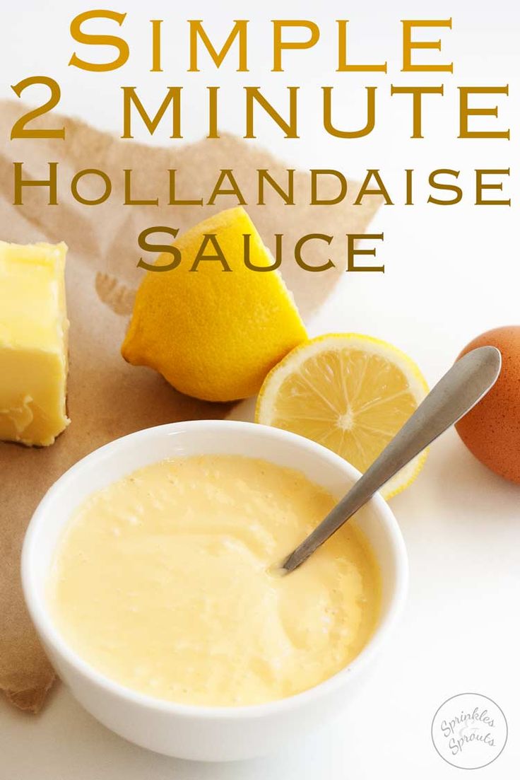 a bowl of hollandaise sauce next to sliced lemons