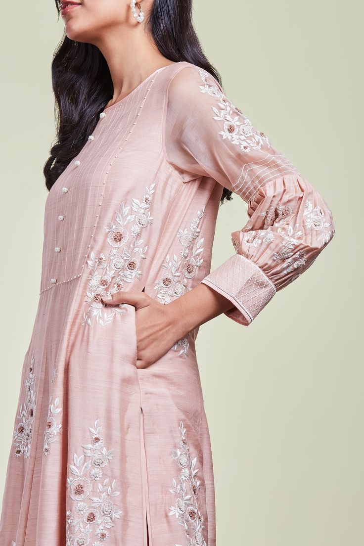 Pink kurta with applique embroidered floral motifs. Comes with pant and dupatta.
Components: 3
Fabric: Tussar georgette, Organza
Neckline: Round
Sleeve Length: Bracelet
Color: Pink
Embroidery
Scallop hem on kurta
Side pockets on kurta
Bishop sleeves on kurta
Front button placket on kurta
Applique embroidered floral motifs on pant
Applique embroidered floral motifs on dupatta
Embroidered lace trim detail on dupatta border - Aza Fashions Transitional Anarkali Palazzo Set With Floral Embroidery, Intricate Embroidered Chanderi Palazzo Set, Anarkali Embroidered Dress Designer Wear, Navratri Resham Embroidery Straight Kurta, Festive Raw Silk Dress With Resham Embroidery, Designer Embroidered Straight Kurta Dress For Diwali, Floral Embroidered Straight Kurta Dress For Eid, Designer Wear Embroidered Straight Kurta Dress, Floral Embroidered Straight Kurta For Eid