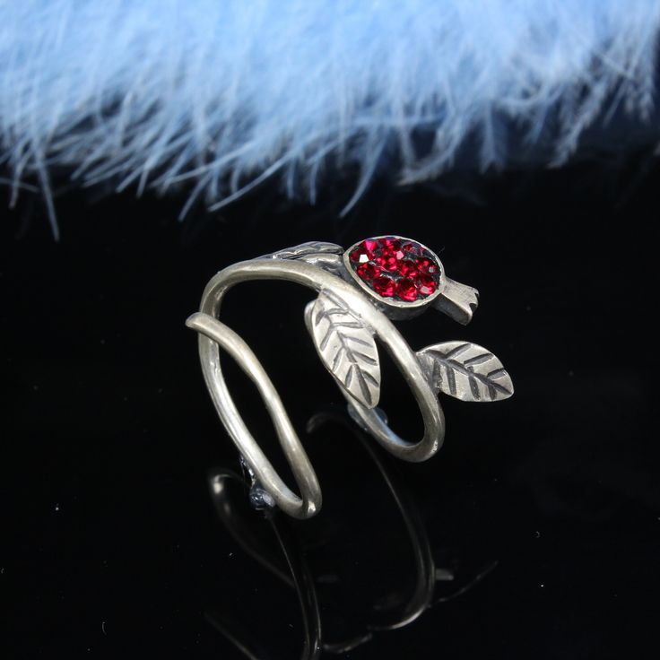 "Sterling Silver Adjustable Pomegranate Persephone Dainty Ring, Statement Gift For Her Red Crystal Stone Fruit Double Ring, Armenian Jewelry Handmade. Silver polished. In Armenia, pomegranate is one of the most recognizable symbols of the country. In Armenian mythology, pomegranate symbolizes fertility and good luck. Pomegranate is also a guardian against the evil eye. At weddings in Western Armenia, the bride throws a pomegranate and smashes it into pieces. The scattered pomegranate seeds ensured the bride had children. In Van, Armenian women who wanted to have a son ate a flatbread made from dough mixed with pomegranate seeds. The importance of this fruit is attested to in historical Armenian manuscripts and in stone carvings, where it was used as a popular ornament. One of the most icon Pomegranate Persephone, Armenian Jewelry, Red Pomegranate, Zierlicher Ring, Real Jewelry, Stone Fruit, Red Band, Double Ring, Red Crystals