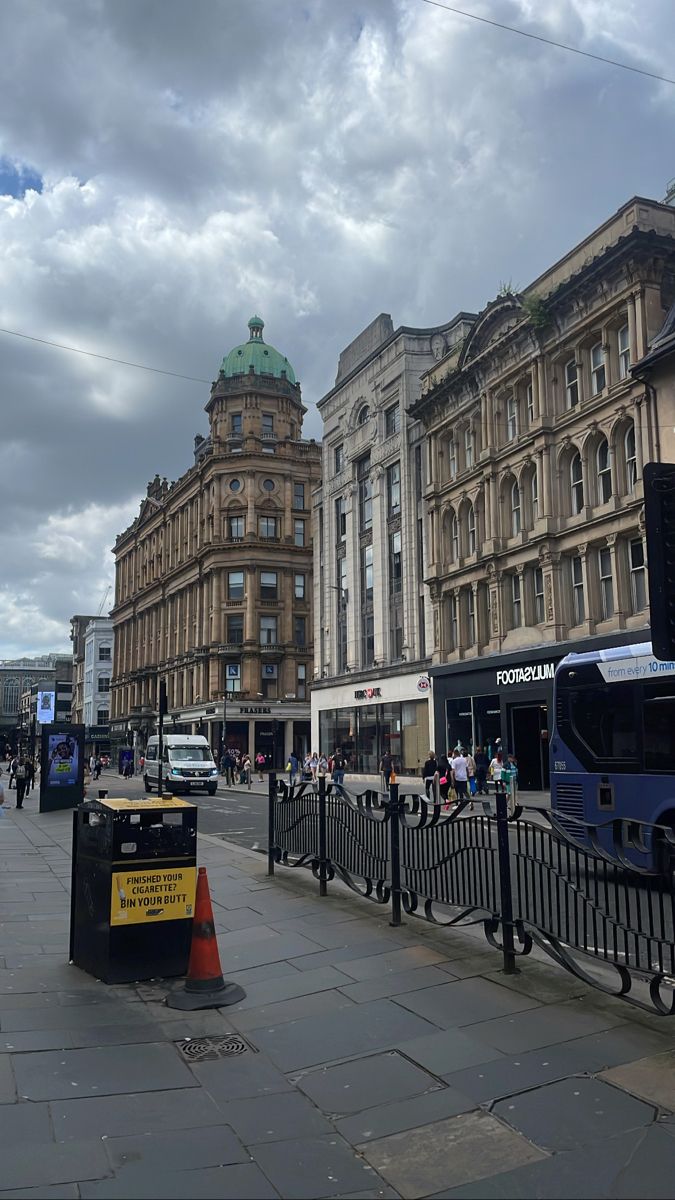 the city street is lined with tall buildings