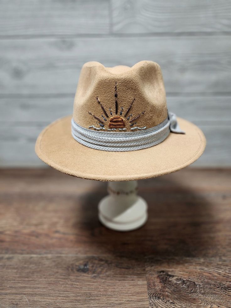 Custom caramel suede fedora with embroidered sun and polyester handmade bow. Size S/M is 55.5cm - 58cm 6cm brim length. Hat band inside the hat for a very comfortable and great fit. Adjustable Country Style Felt Hat For Summer, Adjustable Flat Brim Felt Hat For Summer, Summer Felt Hat With Adjustable Flat Brim, Summer Adjustable Felt Hat With Flat Brim, Summer Country Style Felt Hat With Short Brim, Country Style Felt Hat With Short Brim For Summer, Country Style Wide Brim Felt Hat For Summer, Beige Felt Hat For Summer Rodeo, Adjustable Brown Felt Hat For Summer