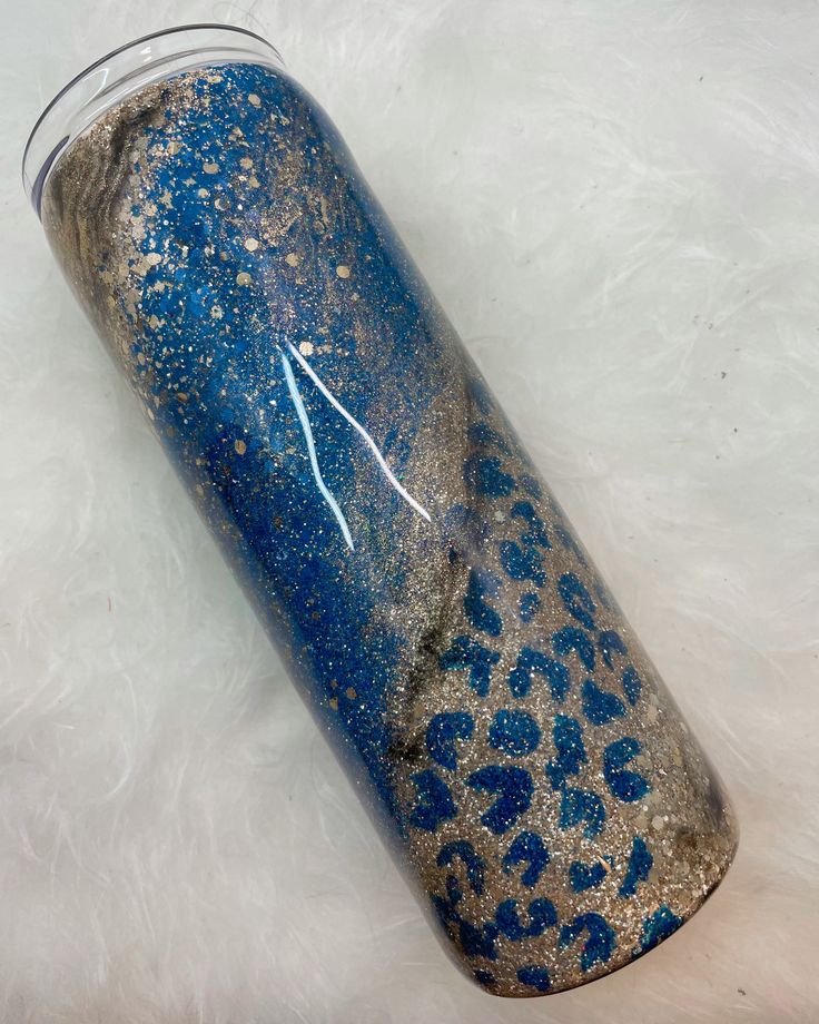 a blue and gold leopard print tumbler with the number one on it's side