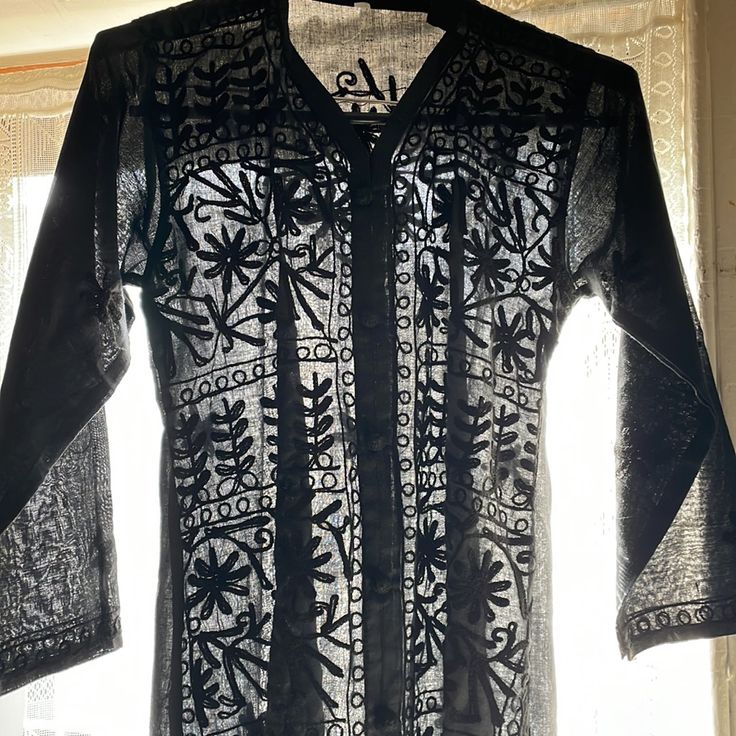 Kurtan Style Short Tunic. Black-On-Black Embroidery. Two Side Slits. Pull Over V Neck. Very Chic With Black Leggings Or A Black Skirt. Crisp And Never Worn. Black Kurta With Floral Embroidery For Eid, Black Long Sleeve Kurta For Festival, Fitted Black Kurta With Floral Embroidery, Black Embroidered Fitted Kurta, Black Fitted Kurta With Intricate Embroidery, Fitted Black Kurta With Intricate Embroidery, Black Bohemian Tunic Kurta, Black Bohemian Style Tunic Kurta, Black Long Sleeve Kurta With Chikankari Embroidery