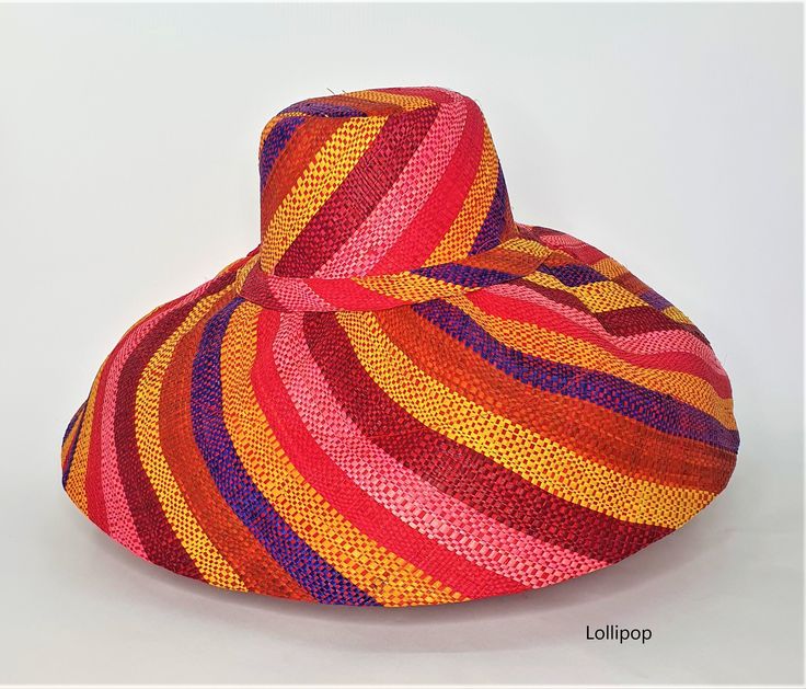 Raffia Curve Large Brim Hat in Lollipop      These amazing hats are dyed, loomed and sewn all by hand. Made in Madagascar. The hats are great sun protection having 2 layers on the brim and around the crown, 3 layers for crown top. Hats can be rolled up for packing in handbag or suitcase.       Measures 15cm brim.      Ethical, eco-friendly, sustainable.      About Raffia      Raffia is native to Madagascar and a sustainable resource to the country. Collectors go deep in the island to harvest the Multicolor Straw Hat With Flat Brim, Handmade Multicolor Straw Hat For Spring, Multicolor Toquilla Straw Hat With Curved Brim, Multicolor Wide Brim Toquilla Straw Hat, Multicolor Woven Hats With Flat Brim, Artisan Multicolor Sun Hat For Spring, Multicolor Brimmed Toquilla Straw Hat, Multicolor Brimmed Toquilla Straw Sun Hat, Multicolor Flat Brim Toquilla Straw Hat