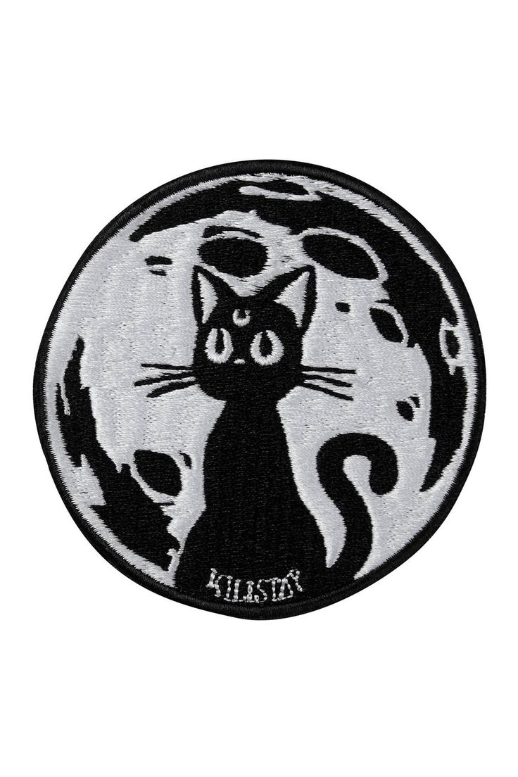 a black and white cat sitting in front of a moon with the word kitty on it