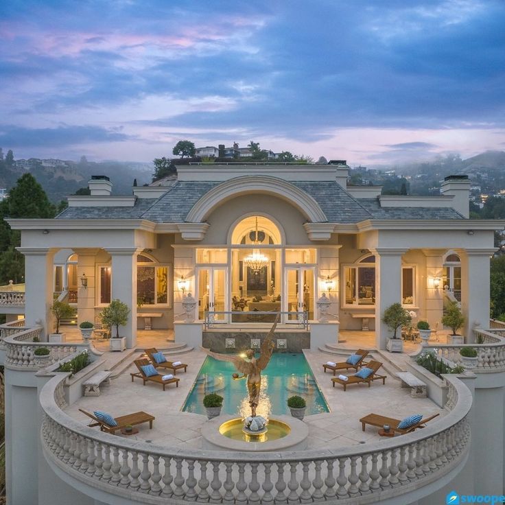 an aerial view of a mansion with a pool