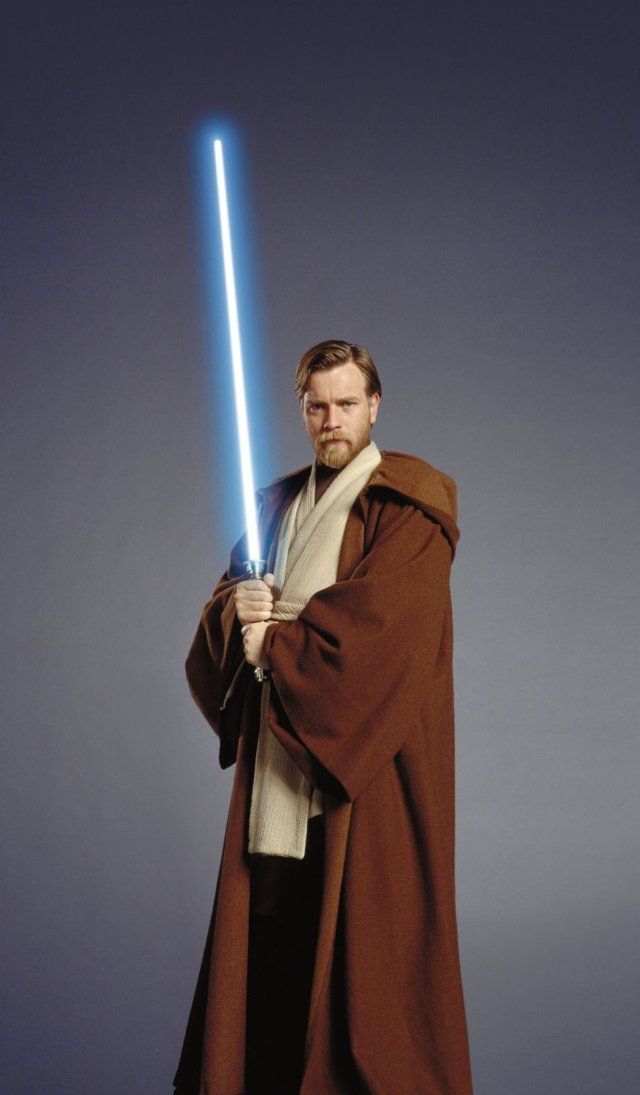 a man in a star wars costume holding a lightsabe