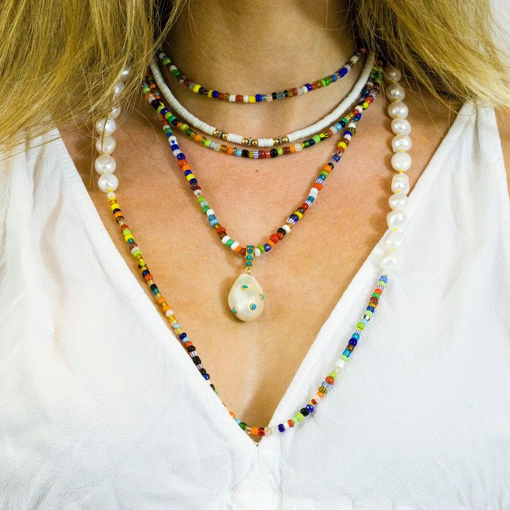 "Bright, vibrant beads make this necklace perfect addition to your summer sundress or a white blouse. African glass beads and white freshwater pearls are hand knotted along the silk cord to create a colorful and bright strand. Alone or layered with your favorites, this necklace exudes a playful, eclectic bohemian elegance. Necklace: 43\" Layer this necklace with: https://www.etsy.com/listing/637252353/baroque-pearl-and-turquoise-necklace?ref=shop_home_active_2 You might also like: https://www.et White Bohemian Beads For Jewelry Making, Bohemian White Beads For Jewelry Making, White Bohemian Beaded Necklaces For Festival, Bohemian Multi-strand Pearl Jewelry, Bohemian White Beaded Necklaces For Festival, Bohemian White Necklaces For Festival, Bohemian White Necklace For Festival, Long White Necklace With Colorful Beads, White Long Necklace With Colorful Beads