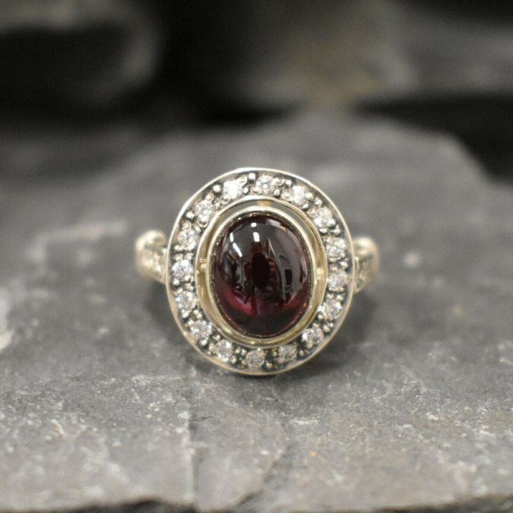 Genuine Garnet Ring set with a Natural Red Garnet in a flawless clarity & color, at 10x8mm (3 Cts) with small CZ Diamonds aroundSolid 925 Sterling Silver ☞ made to last.Click here for ☞ Matching EarringsMatching Pendant ☞ please ask meDetails:• Natural Red Garnet sourced from Mozambique & CZ Diamonds• Garnet: 10x8mm, 3 Ct, cabochon cut• Dimensions: Band width ≈ 2.4mm, thickness ≈ 1mm• Solid 925 Sterling Silver❀ Each Natural Gem is unique & will have Slight variations from the product pictures "n Red Garnet Ring, Victorian Rings, Oval Ring, Garnet Ring, Oval Rings, Red Vintage, Garnet Rings, Cz Diamond, Product Pictures