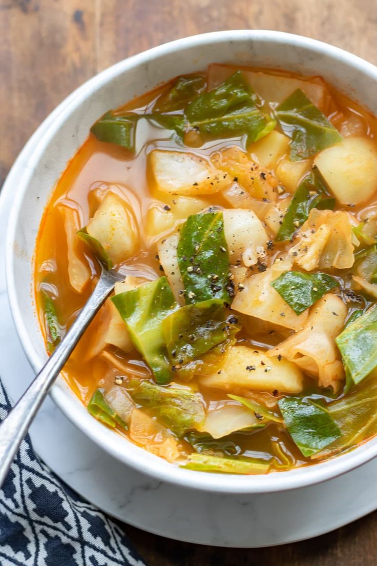 cabbage and potato soup in a white bowl with text overlay that reads how to make cabbage and potato soup