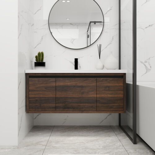 a bathroom with marble walls and flooring, a round mirror on the wall above the sink