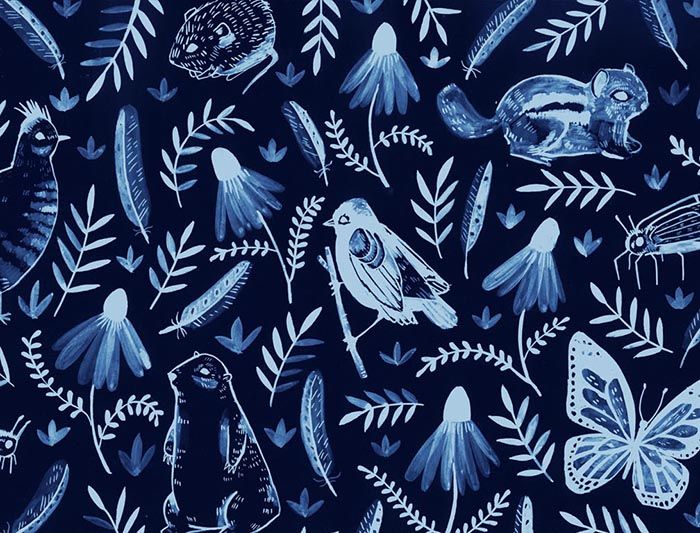 a blue and white pattern with birds, flowers, and butterflies on it's surface