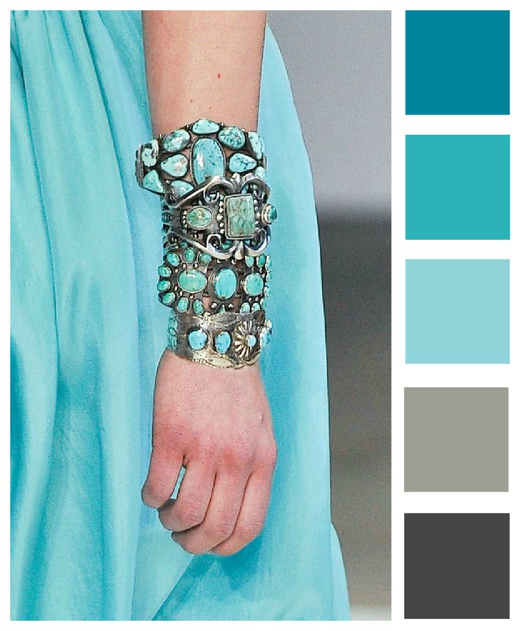 a woman's hand wearing a bracelet with turquoise and grey accents on it, in front of a color palette