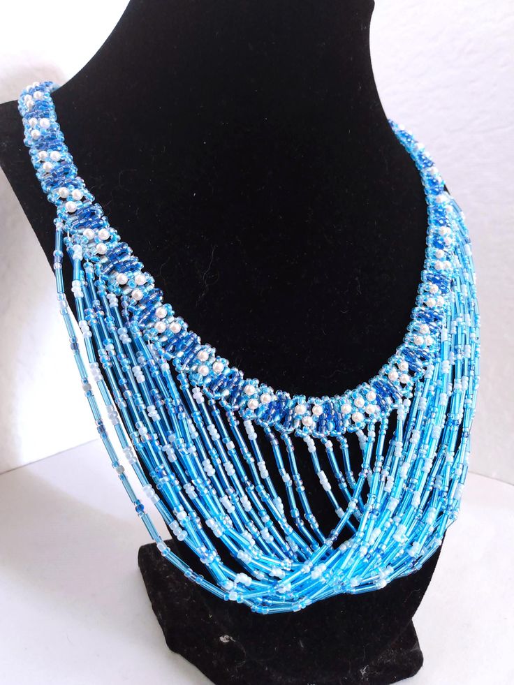 A handmade glass beaded necklace that is perfect for any occasion: parties, holidays, birthdays, anniversaries. All products are hand-crafted by my mother. Dimensions: - Length: 28.5 cm - Width: 22.0 cm - Height: 2.0 cm Lightweight, high quality with a beaded hook as a clasp.  Acrylic Pearls: 8 mm. Will respond to concerns and suggestions promptly. Shipping costs: Free Domestic Shipping. All orders are sent by air-mail with tracking number. Time of delivery: Estimated 1-3 days for domestic shipping; international make take 7-14 days. Feel free to check out our other similar products! https://noorsjewelers.etsy.com Bohemian Blue Necklace For Celebration, Adjustable Blue Beaded Necklaces For Party, Adjustable Turquoise Beaded Necklaces For Party, Blue Necklaces With Colorful Beads For Party, Turquoise Beaded Necklace With Dangling Beads For Party, Handmade Turquoise Necklace For Celebration, Blue Beaded Necklaces With Polished Beads For Wedding, Turquoise Beaded Necklace With Colorful Beads For Parties, Blue Round Bead Necklaces For Parties