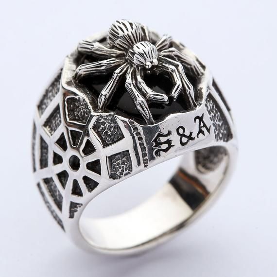 - We crafted this ring from 925 sterling silver;- 925 hallmark can be found on the ring’s exterior;- Comes with a black stone inlaid;- Ring face dimensions: 19 mm x 23 mm;- Weight: 17 grams;- The ring is made by hand. Gothic Sterling Silver Rings For Gift, Black Stainless Steel Engraved Ring As Gift, Black Stainless Steel Engraved Ring For Gift, Black Skull Ring With Open Design As Gift, Black Open Skull Ring As A Gift, Nickel Free Sterling Silver Gothic Rings, Nickel-free Gothic Sterling Silver Rings, Black Stainless Steel Skull Ring As Gift, Black Stainless Steel Skull Ring For Gift