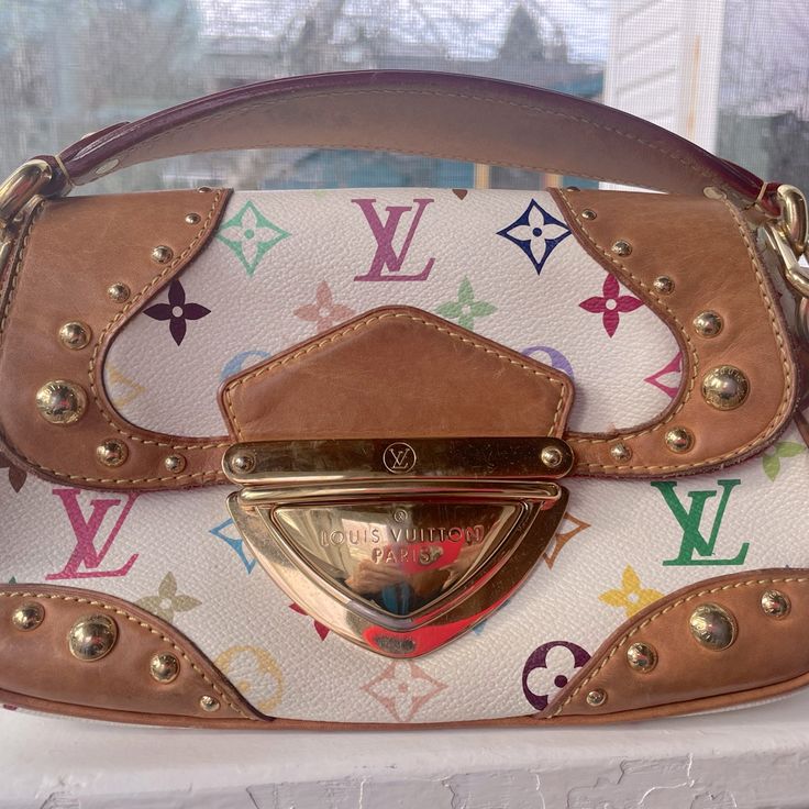 Louis Vuitton White Monogram Multicolor Handbag With Goldtone Hardware. The Lining Is Red Alcantara. There Are 2 Spots With Slight Wear On Inside Flap.The Strap Is Leather With A Gold Chain. There Is An Inside And Outside Pocket. There Are D Rings For A Cross Body Option. Measurements Are 13.5” L X 6.5 “ W X 9. 1 “ H. The Handle Drop Is 11”. Includes Dust Bag And Certificate Of Authenticity. Takeshi Murakami, Louis Vuitton White, D Rings, How To Make Handbags, Red Gold, Louis Vuitton Bag, Gold Chain, Gold Chains, Cross Body