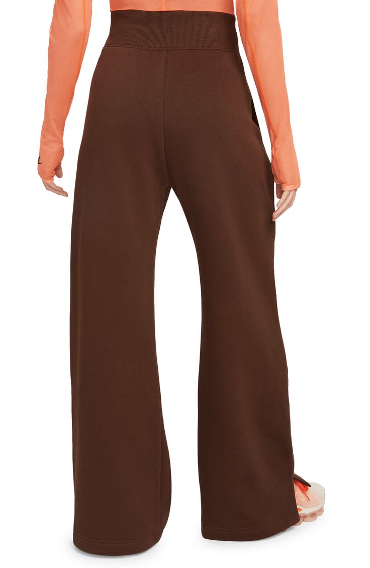 Get incredibly comfy in these wide-leg sweats with split hems so you can show off your favorite footwear. Taller ribbing at the waist, as well as an exaggerated drawcord, ensure the look is anything but basic. 28" inseam; 12" front rise (size Small) 80% cotton, 20% polyester Machine wash, tumble dry Imported Nike Full Length Sweatpants For Loungewear, Nike Sporty Bottoms For Fall, Wide Leg Sweatpants For Fall, Nike Athleisure Pants For Fall, Wide Leg Pants With Ribbed Waistband For Fall, Nike Sweatpants For Loungewear In Fall, Nike Sweatpants For Fall Loungewear, Casual Nike Sweatpants For Fall, Nike Casual Sweatpants For Fall