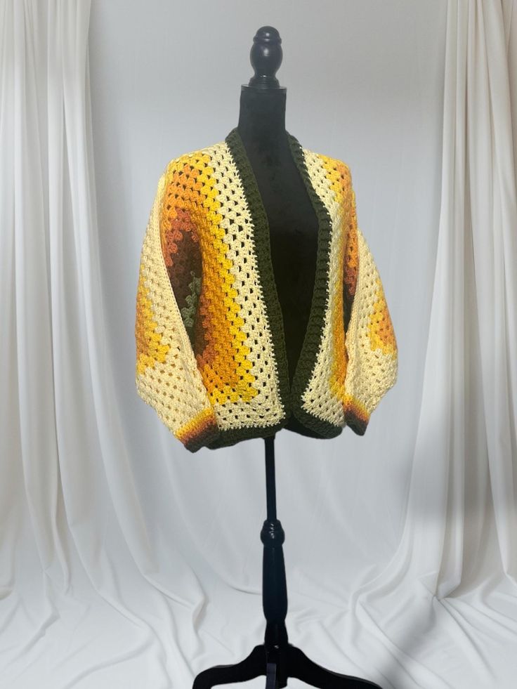 Crochet hexagon cardigan. Crocheted with acrylic yarn. Perfect for fall and winter seasons. Colors range from yellow, orange, brown, and green.  Care instructions: Machine wash in warm water Lay flat to dry DO NOT IRON DO NOT BLEACH One Size Acrylic Yarn Cardigan For Fall, Granny Square One Size Outerwear For Fall, Crochet Acrylic Outerwear For Fall, One Size Crochet Sweater For Fall, Long Sleeve Acrylic Yarn Cardigan For Fall, Handmade One Size Fall Cardigan, Yellow Open Front Cardigan For Fall, Handmade Cotton Cardigan For Fall, Handmade Yellow Sweater For Fall