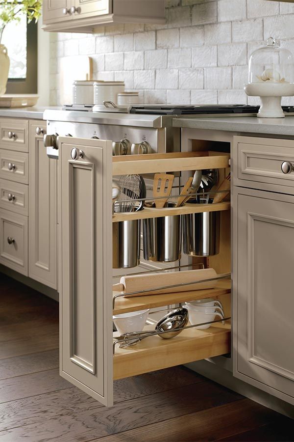 an open cabinet in the middle of a kitchen