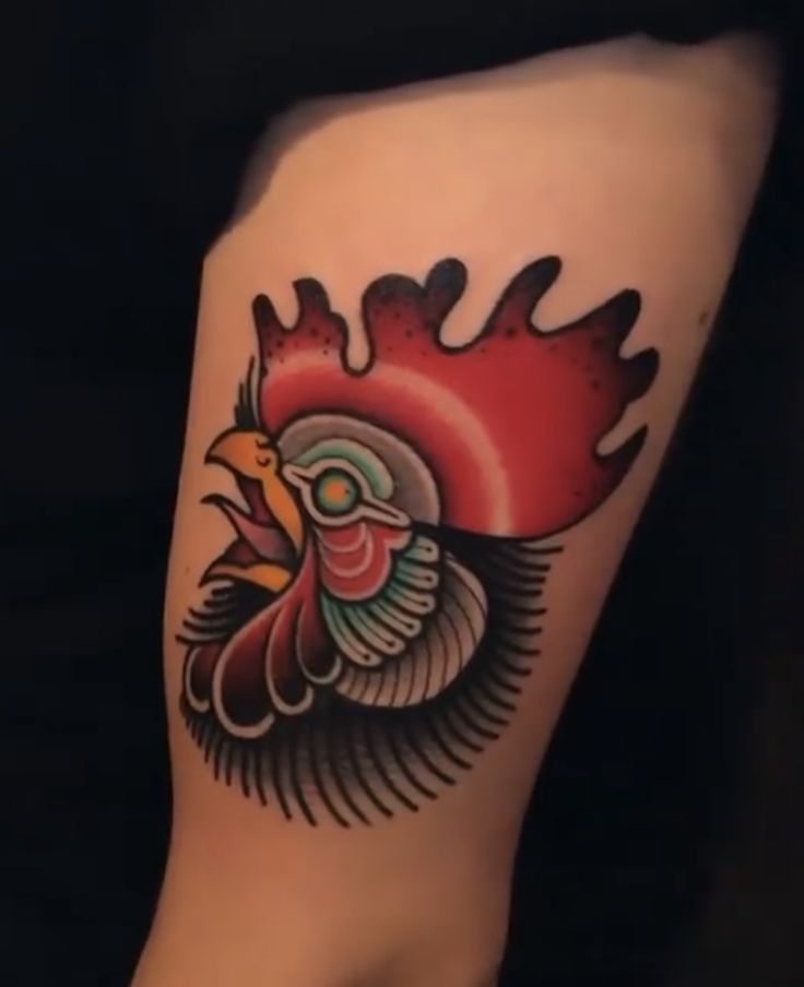 a close up of a person's leg with a tattoo design on it and a rooster