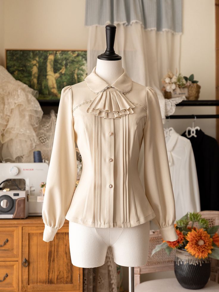 Add a touch of Victorian elegance to your wardrobe with this beige long-sleeve shirt featuring a detachable jabot on the neckline. Perfect for adding a sophisticated and gothic twist to your outfit, this versatile piece can be dressed up or down for any occasion.  This price includes a shirt and a detachable jabot.   	 		 			Size 			S 			M 			L 			XL 			2XL 		 		 			Shoulders 			38 			39.5 			41 			42.5 			44 		 		 			Bust 			86 			92 			98 			104 			110 		 		 			Waist 			68 			74 			80 			86 			92 		 		 			Sleeve Length 			59 			60 			61 			62 			63 		 		 			Bicep 			36 			38 			40 			41 			42 		 		 			Full Length 			58 			59 			60 			61 			62 Fitted Beige Long Sleeve Blouse, Beige Fitted Long Sleeve Blouse, Elegant Cream Long Sleeve Tops, Elegant Long Sleeve Cream Tops, Elegant Fall Tops With Detachable Collar, Elegant Long Sleeve Blouse With Detachable Collar, Chic Fitted Top With Detachable Collar, Beige Formal Tops For Fall, Classic Fitted Top With Detachable Collar