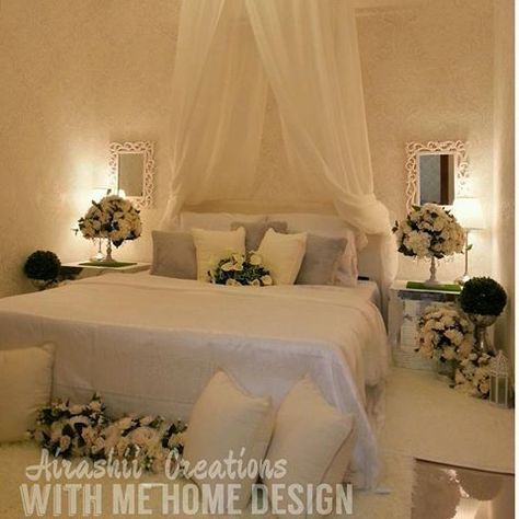 a bed with white linens and flowers on it