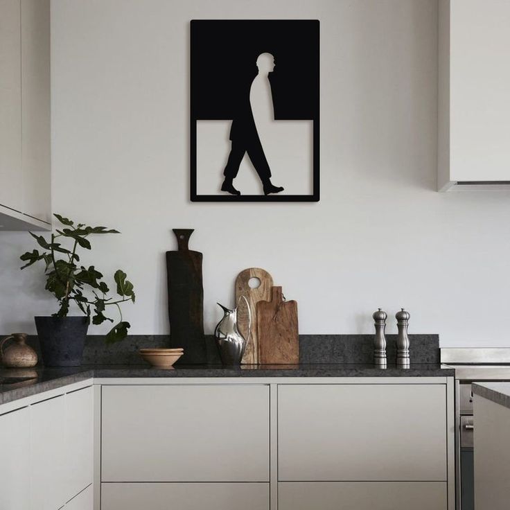 a black and white photo hanging on the wall above a kitchen counter with a cutting board