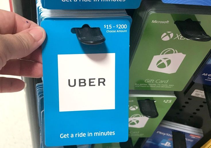 a hand is holding up a card that says user get a ride in minutes on it