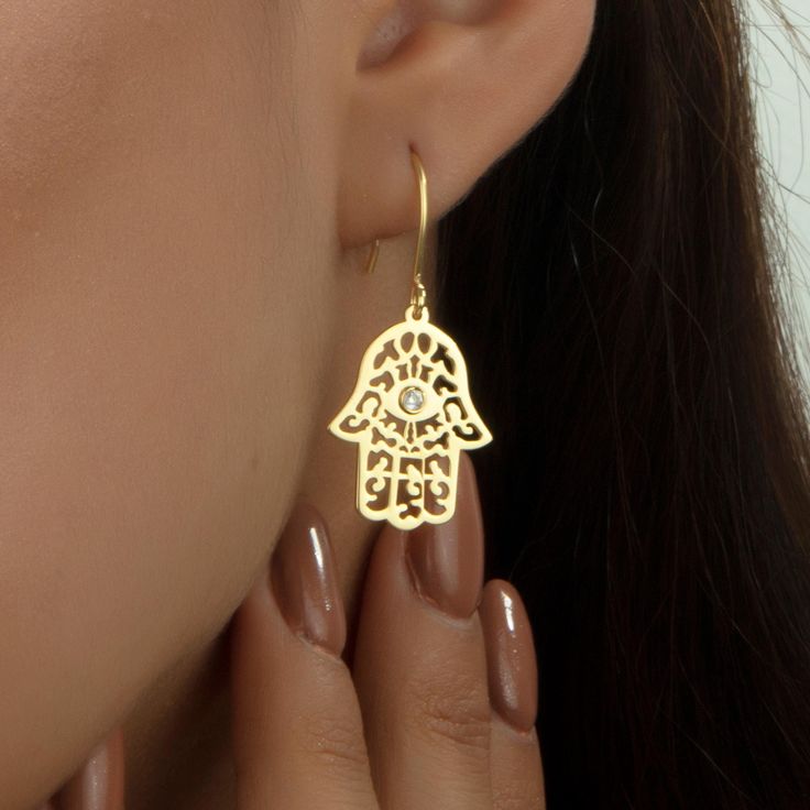 14K Gold Plated Hamsa Earrings, Gift for Her, Hand of Fatima Earrings, Christmas Gifts, Mothers Day Gift, Earrings for Women, Jewelry - HAMSA ∙ EARRINGS - We create dainty, unique, and personalized jewelry perfect for any occasion, from Christmas gifts and birthdays to Mother's Day, anniversaries, and bridesmaid gifts. Explore our collection to find the ideal piece for celebrating life's special moments. OTHER FEATURES * High-Quality Materials: Crafted from 925 Silver, not stainless steel. * Color Options: Offered in Gold, Rose Gold, and White Gold. * Eco-Friendly and Hypoallergenic: Nickel-free, tarnish-resistant, and made with eco-friendly materials. * Packaging: Comes in a lovely jewelry box, perfect for gifting. * Customer Support: We're here to assist with any product issues or inquir Gold Plated Pierced Crystal Earrings As A Gift, Pierced Yellow Gold Crystal Earrings As Gift, Yellow Gold Pierced Crystal Earrings For Gift, Yellow Gold Pierced Crystal Earrings As Gift, Hamsa Earrings, Birthstone Earrings, Earrings Christmas, Hand Of Fatima, Birthstone Earring