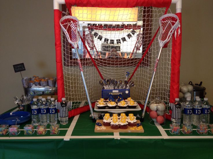 a sports themed dessert table with cupcakes and snacks on the sidelines in front of a goal