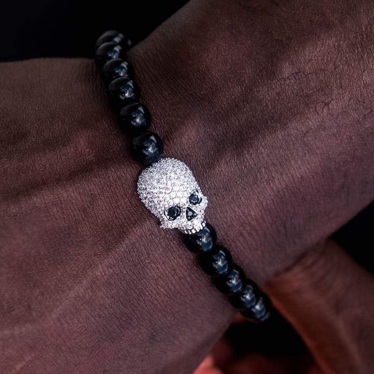 Introducing the Skull Beaded Bracelet, an added edge to your wrist stack. Featuring a row of sleek black beads and a bold iced out skull head in the center, this exclusive piece will leave a lasting impression. The elastic stretch ensures an adjustable fit, great for everyday wear and pairs perfectly with the Sphere Iced Beaded Bracelet. This product is guaranteed for life – GLD will repair or replace the item should you experience any defects in craftsmanship or breakage. Specifications - Width Wrist Stack, Wrist Stacks, Skull Head, Beaded Skull, Vermeil Jewelry, Custom Earrings, Gold Plated Bracelets, Pendant Bracelet, Drop Necklace