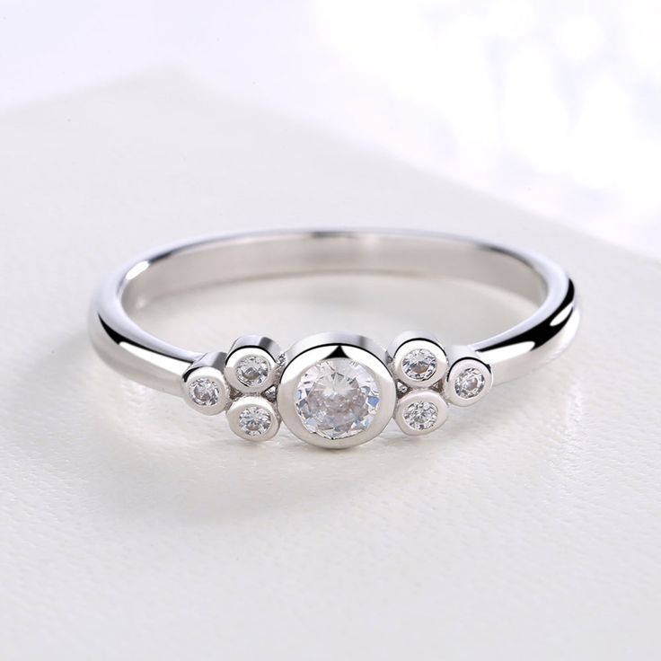 Looking for the perfect small ring to propose your love with, or give as a gift? This stunning all-white round ring from Swarovski will not let you down. Made from sterling silver, the crystal accents add a decorative touch. The simple style and highly polished finish make it easy to wear every day and make for a great item for birthdays or anniversaries. The perfect proposal ring, this delicate beauty is made from sterling silver and Swarovski crystals, giving you the look you want for your spe Simple Rings With Small Diamonds Silver, Sterling Silver Crystal Ring With Diamond Accents, White Gold Sterling Silver Birthstone Promise Ring, Silver Sterling Birthstone Ring For Anniversary, Silver Birthstone Ring For Promise, Diamond White Cubic Zirconia Rings For Gift, Diamond White Cubic Zirconia Rings As Gift, White Gold Cubic Zirconia Rings As Gift, White Gold Cubic Zirconia Rings For Gift