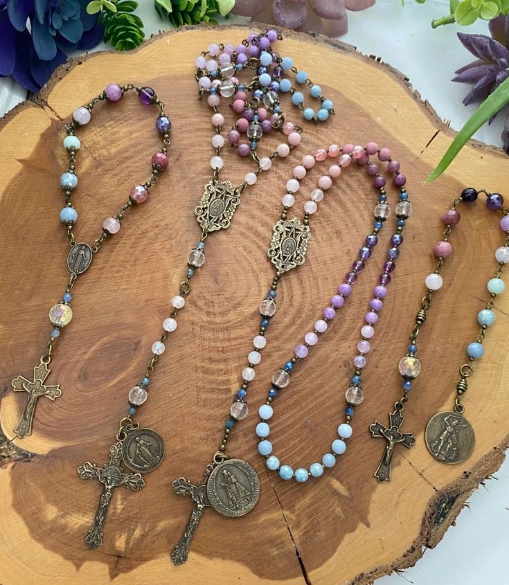 Beautiful protection rosaries handcrafted with high quality gemstones and accented with detailed, double-sided Mother Mary/Archangel Michael medals and crucifixes.  All beads used are made from natural gemstones. Therefore, each bead is unique and might have slight color difference or imperfections.  Size & Customization Please message me for alternate size options. I am happy to accommodate custom orders. Please message me with your specific requests.  Care Many gemstone, crystal, and wood beads should not get wet, and stretch cord and wire can lose strength when wet or exposed to lotions/oils. Therefore, precautions should be taken to prolong the life of the piece. Do not bathe, shower, or swim while wearing jewelry. Extended exposure to moisture or humidity, or excessive stress to the p Healing Jewelry With Miraculous Medal And Round Beads, Spiritual Crucifix Necklace With 8mm Beads, Spiritual Healing Jewelry With Miraculous Medal, Healing Rosary With Miraculous Medal And Round Beads, Healing Rosary With Miraculous Medal, Spiritual Crucifix Jewelry With 8mm Beads, Adjustable Spiritual Rosary With Miraculous Medal, Bohemian Rosary With Natural Stones For Gifts, Spiritual Rosary With Miraculous Medal And Crucifix