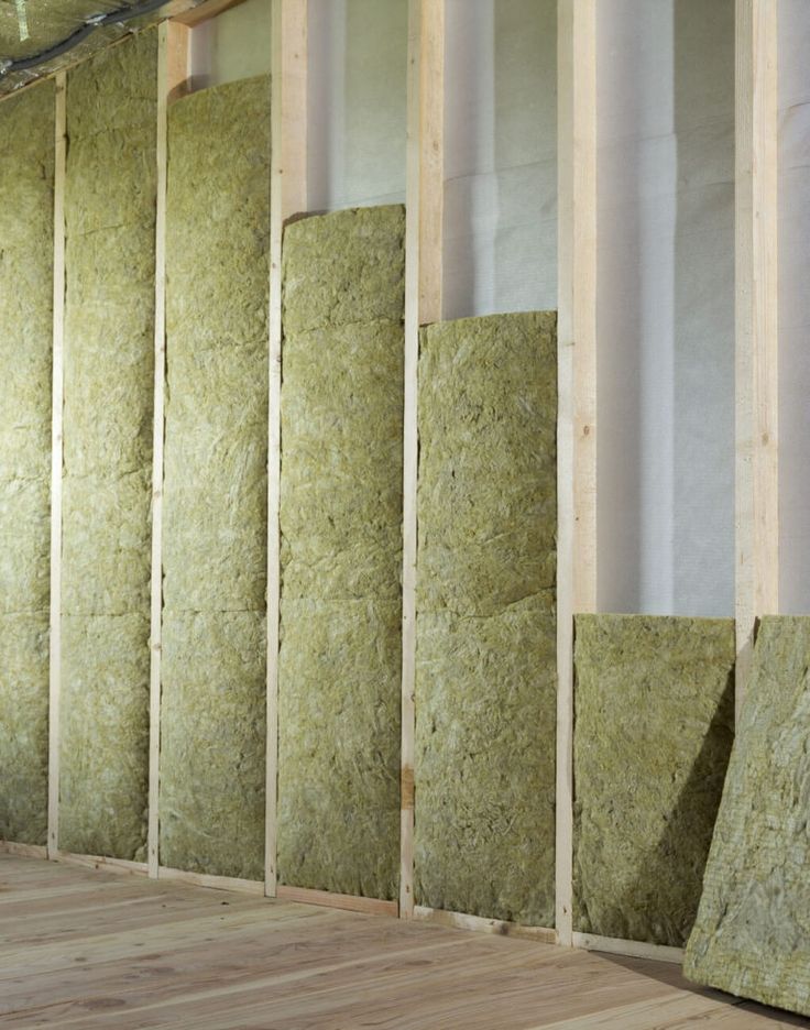 a room that has some insulation on the wall and wood flooring in front of it