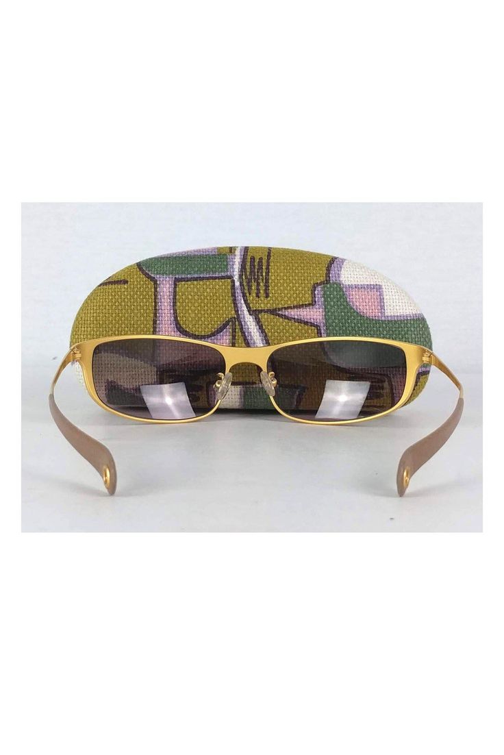 Take these fabulous sunnies everywhere you go! Made with a chic rectangle shaped gold frame with brown gradient lenses. Gold frames Brown gradient lens Made in Italy Rectangle frames Leather trim on arms Comes w/ case & cloth Very light marks on frame Lens width 2.75" Lens height 1.5" Gold Rectangular Tinted Sunglasses, Gold Rectangular Sunglasses With Tinted Lenses, Retro Gold Sunglasses With Uv Protection, Gold Retro Sunglasses With Uv Protection, Gold Rectangular Sunglasses With Mirrored Lenses, Formal Gold Rectangular Sunglasses, Designer Gold Square Frame Sunglasses, Chic Rectangular Sunglasses For Travel, Gold Rectangular Sunglasses For Formal Occasions