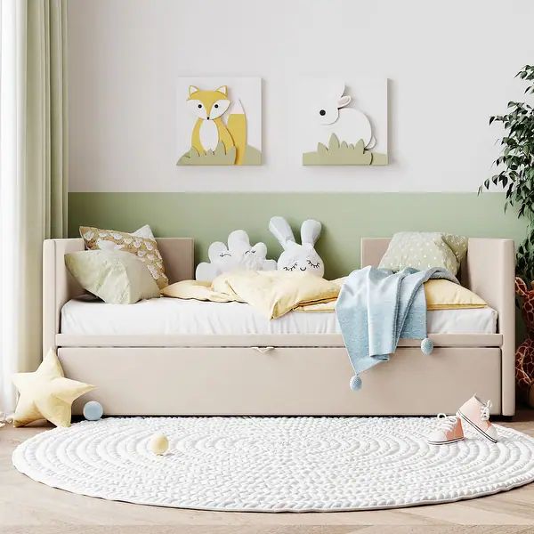 a child's daybed with stuffed animals on it in a living room next to a potted plant