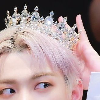 a close up of a person wearing a tiara