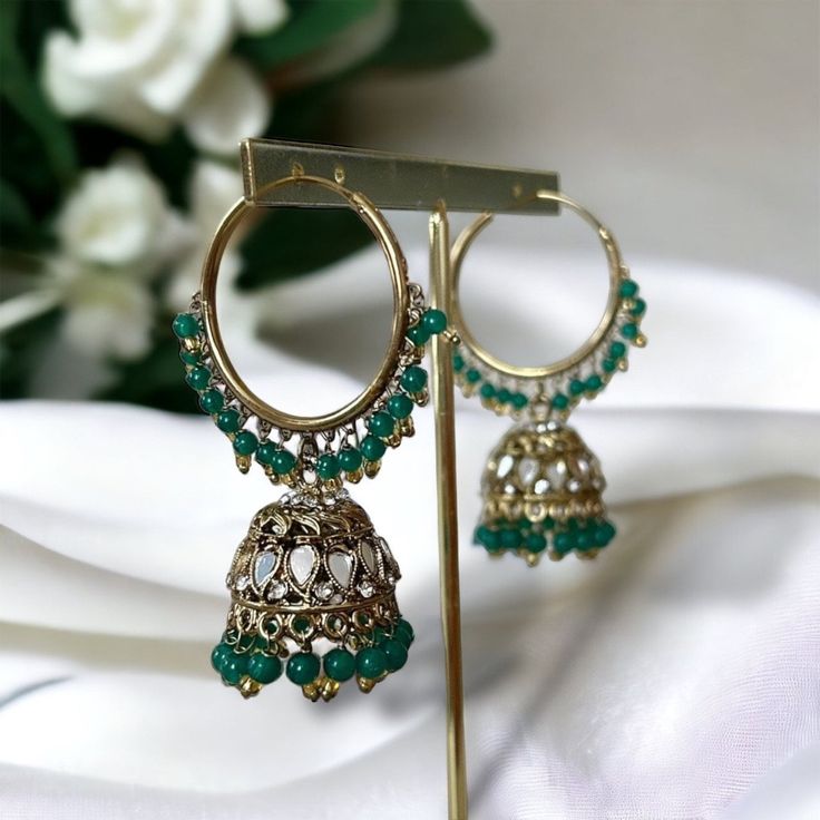 Gold and emerald green hoops with pearl detailing. These have a hoop diameter of 3.4cm and a jhumka drop of 2cm. Please visit our Etsy page for our whole product range.  Jewellery care:  While we try our best to design and create high quality jewellery,  there are some things you can do to extend the longevity of your items. Here are our care tips:  - Keep your jewellery in the pouch that is provided to you in your order to keep it safe, airtight and away from moisture. - Avoid any direct contac Bottle Green Saree, Onam Dress, Desi Jewellery, Green Pearl Earrings, Mirror Detail, Gold And Emerald, Prom Ideas, Green Saree, Green Pearls