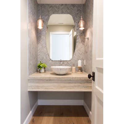 a bathroom with a sink, mirror and light fixture in it's center area