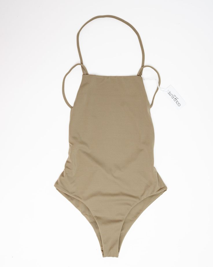 Our Mia one piece is the perfect addition to your beach wardrobe! Featuring a low drop back and side detailing, plus a high leg and solid color design, you'll be sure to turn heads all summer long. Make a splash in this plus-size one-piece from our size-inclusive swimwear collection. Gold Elite Mia One Piece | Olive | Swimsuits | Materials & Care Instructions: ['80% Nylon, 20% Spandex', 'Imported'] Solid Sleeveless One-piece For Pool, Solid Bodysuit For Poolside In Spring, Solid Bodysuit For Spring Poolside Occasions, Solid Color Bodysuit For Poolside Spring Occasions, Solid Color Bodysuit For Poolside In Spring, Summer Sleeveless Bodysuit With Adjustable Straps, One-piece Swimsuit For Beach Season, Solid Swimwear For Spring Beach Party, Solid One-piece Swimwear For Summer