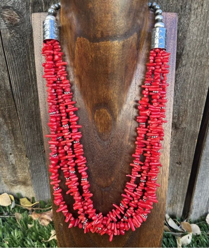 Add a pop of color to your outfit with this beautiful multi-strand necklace. Made with high-quality materials, this piece features red coral beads on a 24-inch sterling silver chain. The beaded design adds a touch of bohemian style, while the bamboo material gives it a unique texture. Perfect for any occasion, this necklace is sure to make a statement. With a Southwestern-inspired design, this necklace is perfect for those who love ethnic and regional styles. The .925 metal purity ensures durability. Whether you're dressing up or down, this necklace will add a touch of elegance to your look. Multi-strand Red Coral Jewelry Gift, Multi-strand Red Coral Beaded Necklace As Gift, Multi-strand Red Coral Beaded Necklace For Gift, Red Double Strand Beaded Necklace With Polished Beads, Handmade Multi-strand Red Coral Jewelry, Multi-strand Red Coral Beaded Necklaces, Multi-strand Red Coral Necklace With Polished Beads, Coral Multi-strand Beaded Necklaces, Red Multi-strand Gemstone Beads Necklace