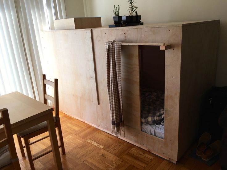 a room that has some kind of cabinet on the floor in front of a table and chairs