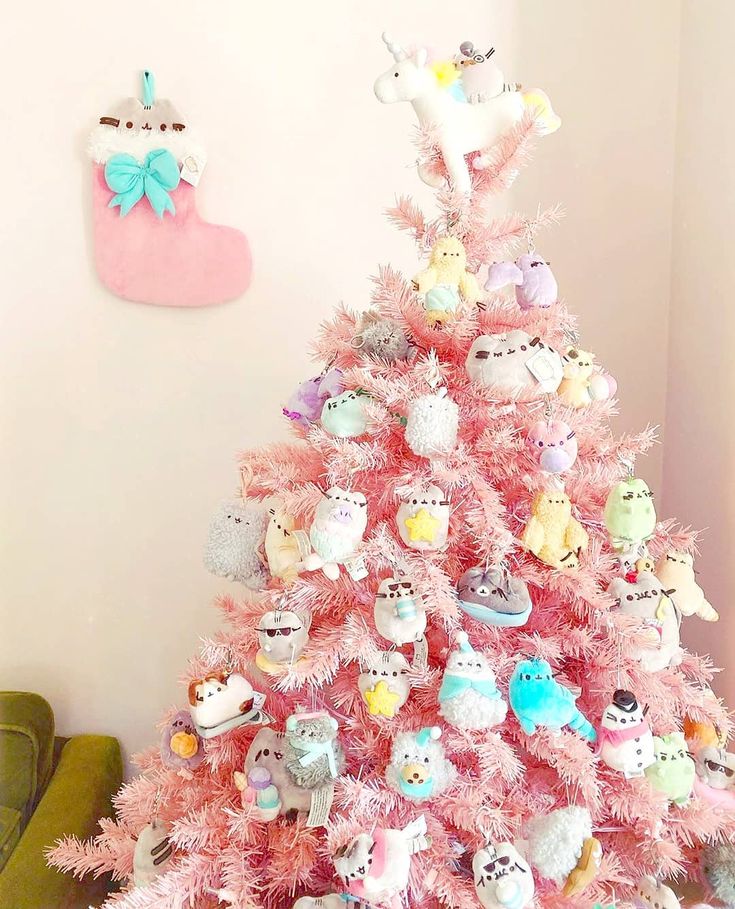 a pink christmas tree with lots of stuffed animals on it