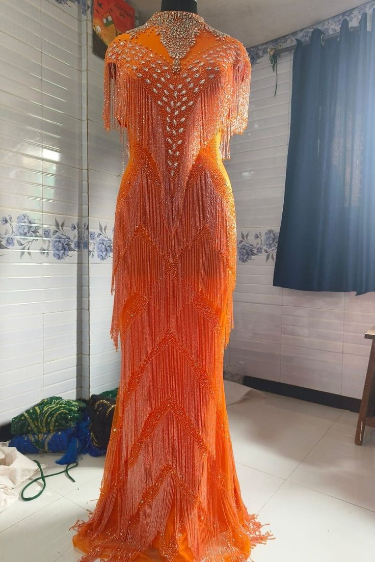 an orange dress on display in a room