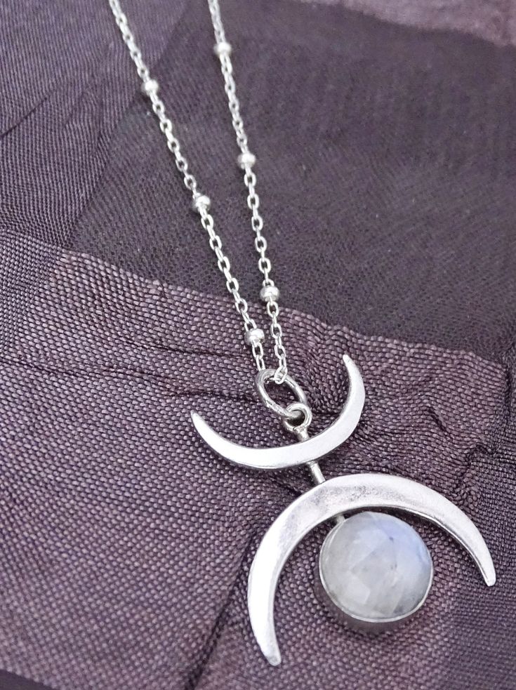 Crescent Moon Necklace Introducing our enchanting Crescent Moon Necklace with Moonstone - Sterling Silver, exclusively designed by The Silver Wing. This captivating necklace is a must-have for moon enthusiasts and celestial jewelry lovers. Crafted from high-quality sterling silver, it radiates elegance and embodies the magic of the night sky. Featuring a unique design with two delicate crescent moons, this pendant is truly one-of-a-kind. The mesmerizing moonstone bezel adds a touch of mystique a Ethereal Jewelry, Moon Necklaces, Goth Jewelry, Silver Wings, Crescent Moon Necklace, Necklace Craft, Celestial Jewelry, The Night Sky, Moon Necklace